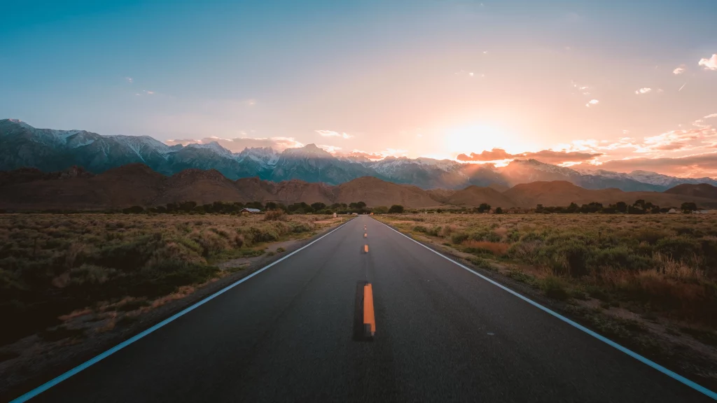 straight-highway road-middle-desert-with-magnificent-mountains-sunset