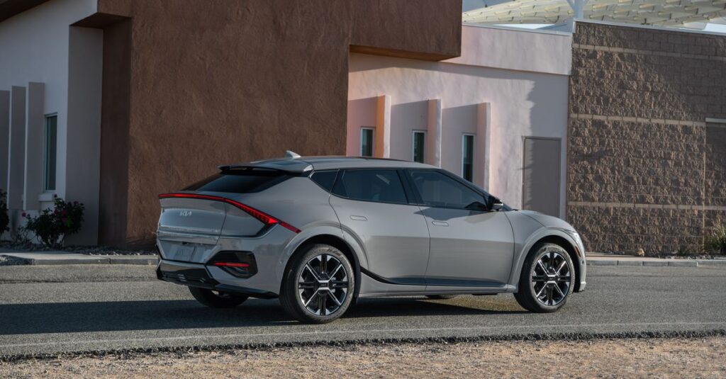 Sleek Kia EV6 GT-Line parked outside a modern building, showcasing futuristic design and innovation.