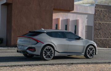Sleek Kia EV6 GT-Line parked outside a modern building, showcasing futuristic design and innovation.