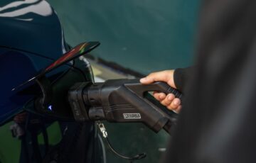 Close-up of an electric vehicle being charged at a station.